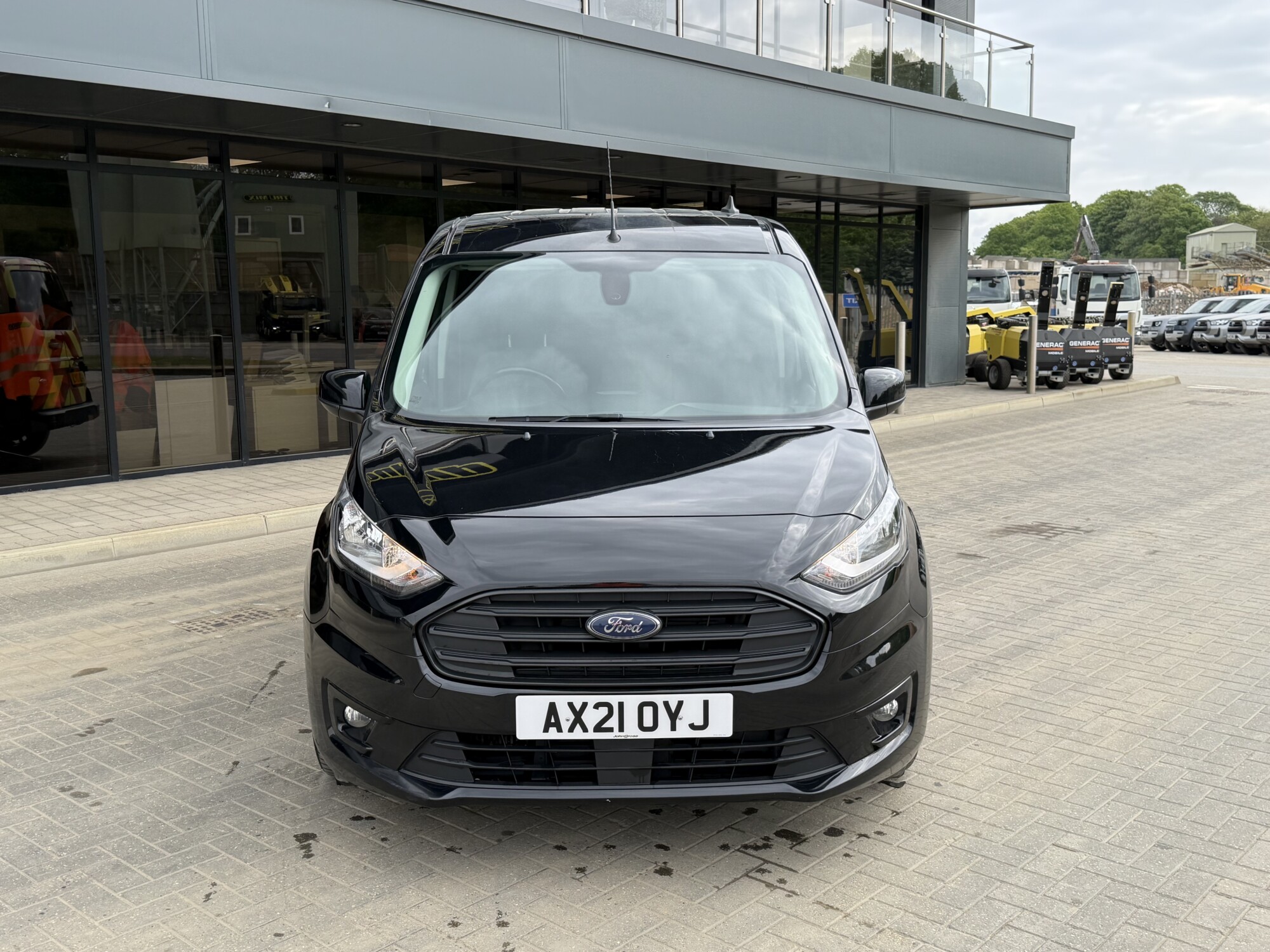 Front view of black Ford Transit Connect van outside Tru7 Group headquarters