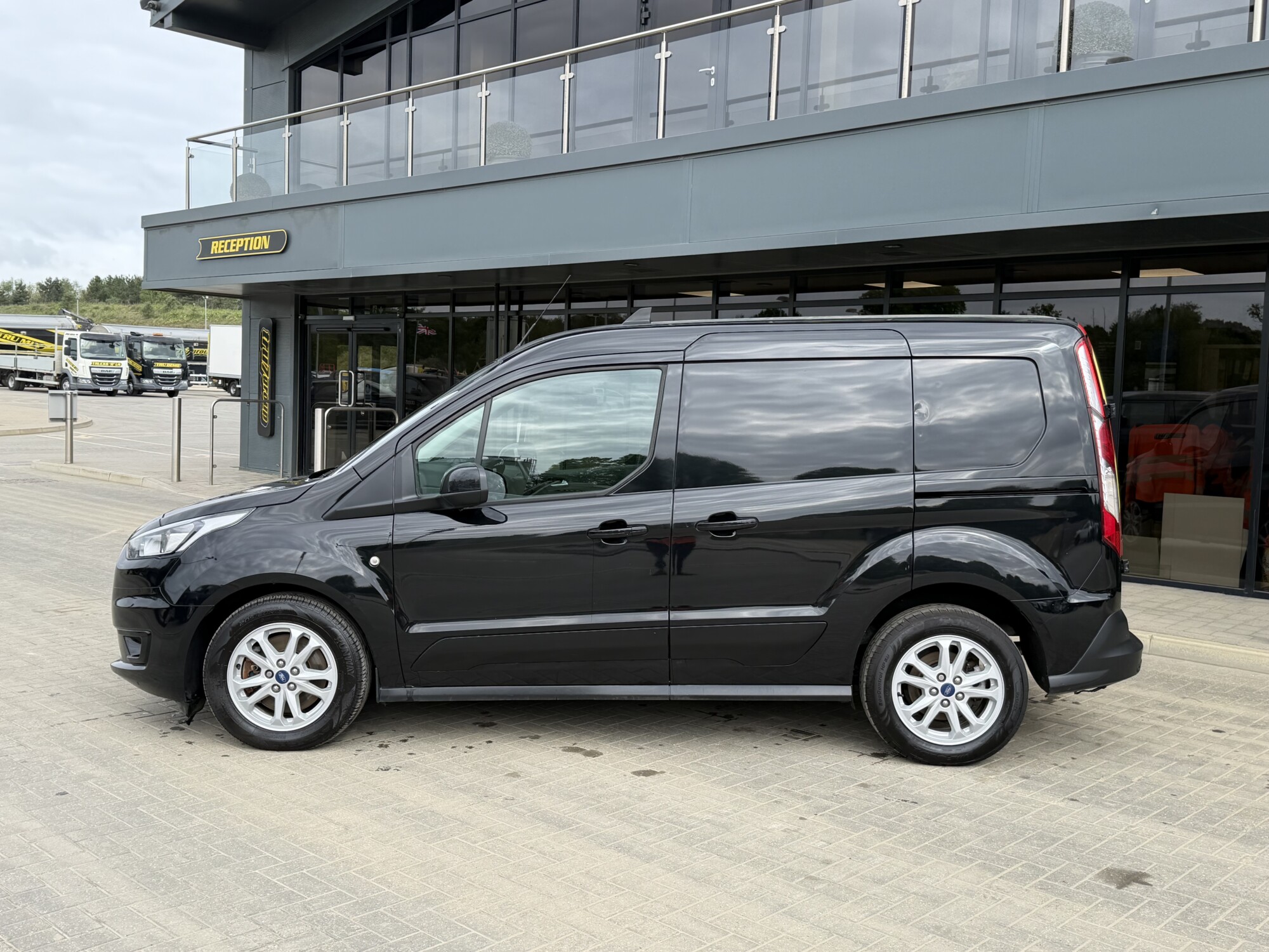 Side view of black Ford Transit Connect van outside Tru7 Group headquarters