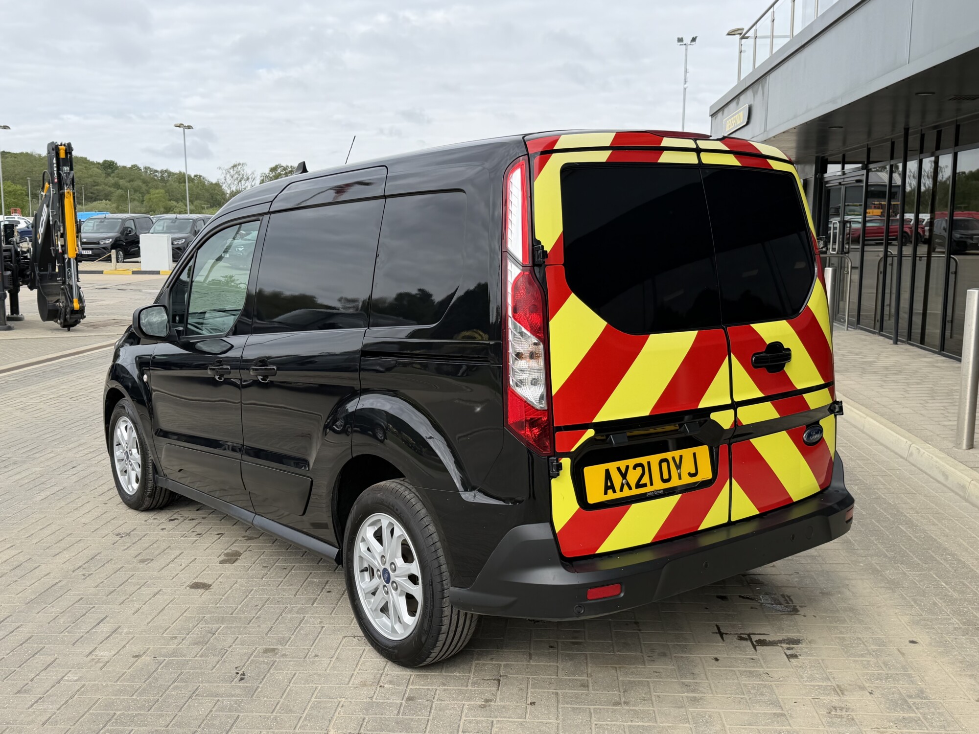 Rear three-quarter view of Ford Transit Connect van with highway chevrons