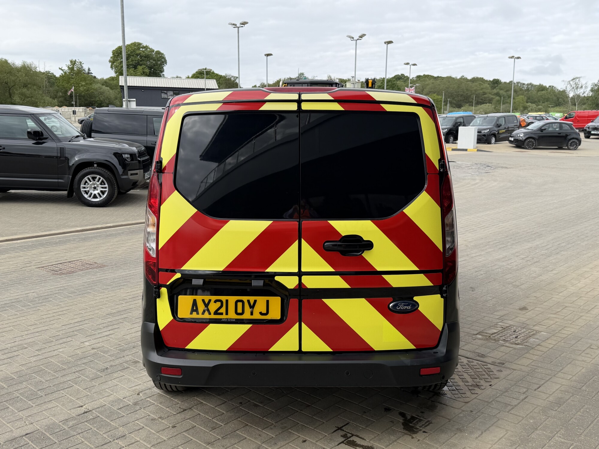 Rear view of Ford Transit Connect van with red and yellow highway chevrons