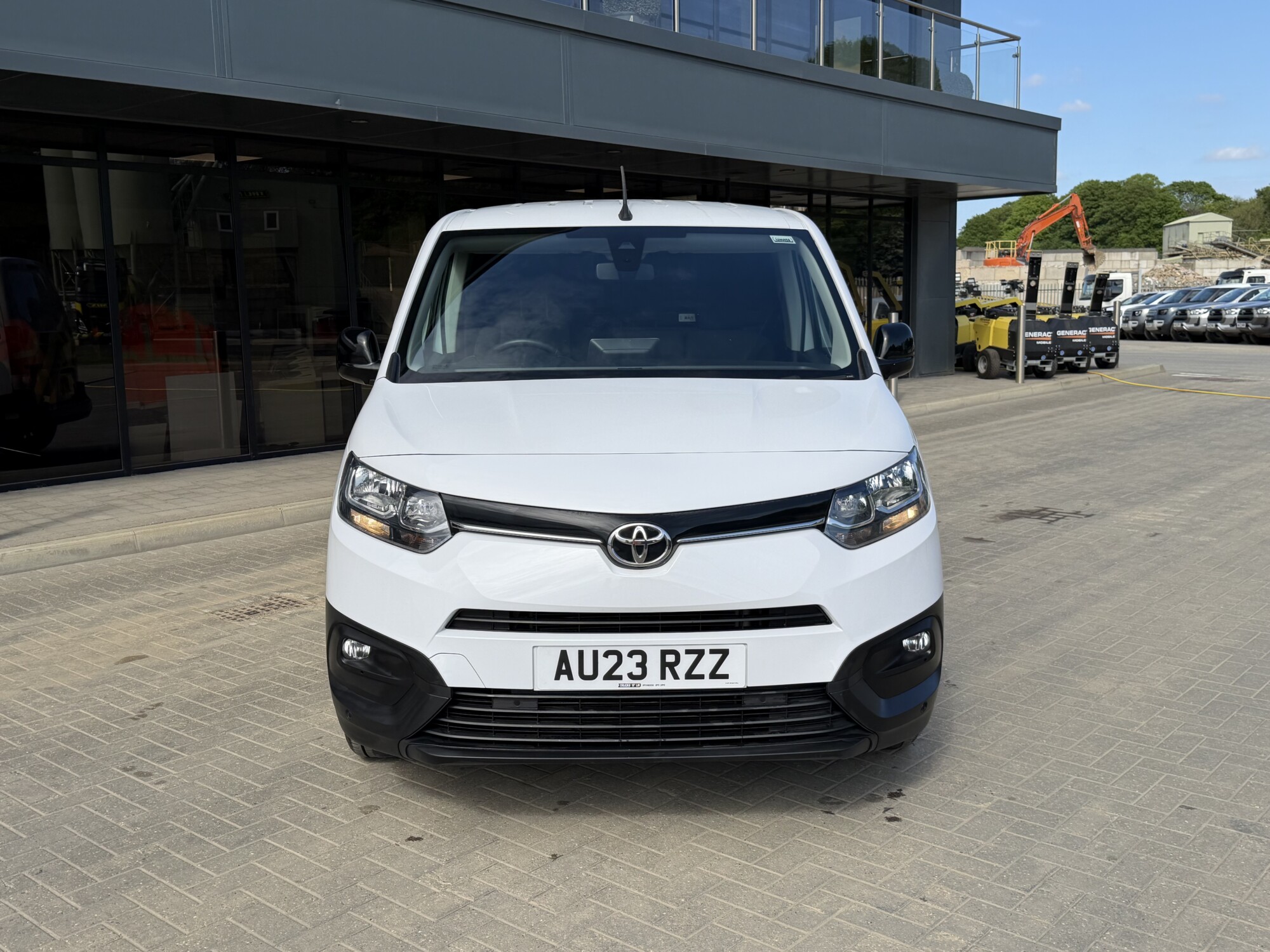 Front view of white Toyota Proace City van outside Tru7 Group building
