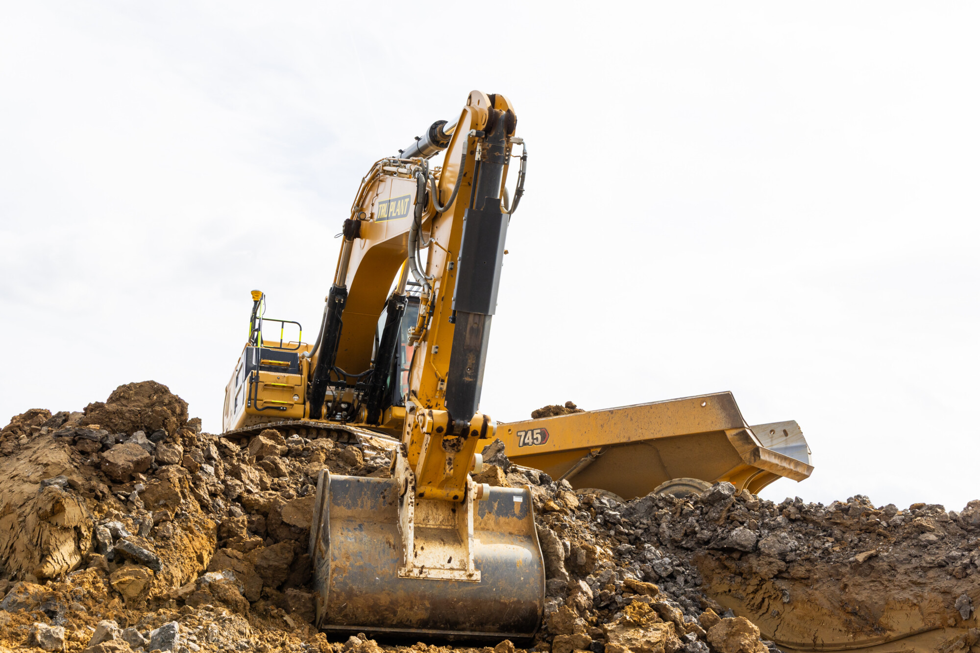 Tru Earthworks excavators and dump trucks carrying out bulk earthworks on a commercial construction site