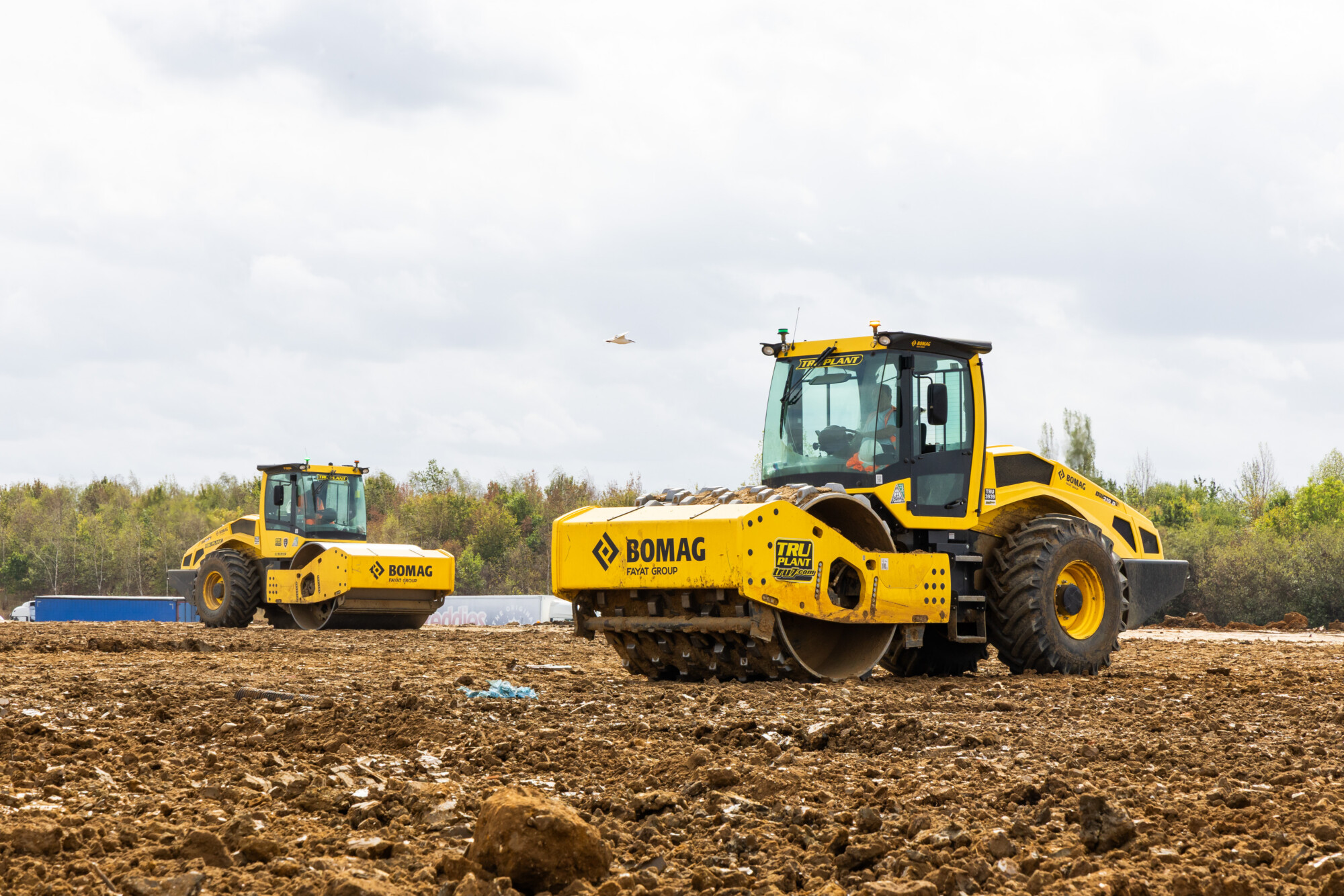 Two Tru Plant Bomag rollers compacting ground on an active earthworks site